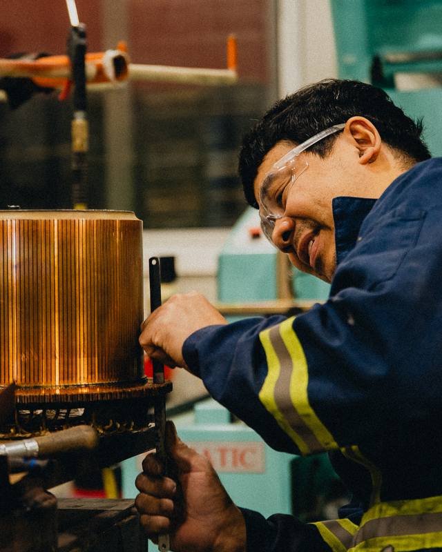 Rogers technician inspecting a copper commutator