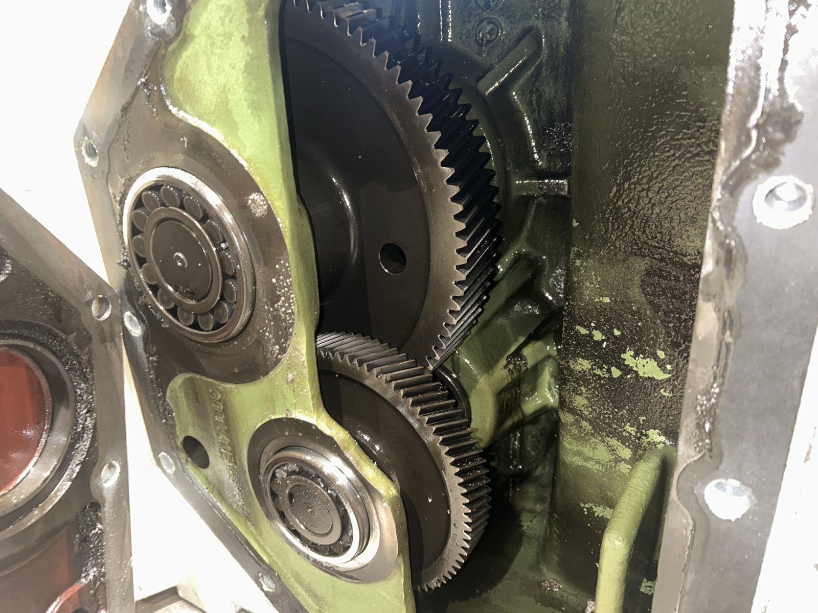 Meshing helical gears and bearings inside a gearbox