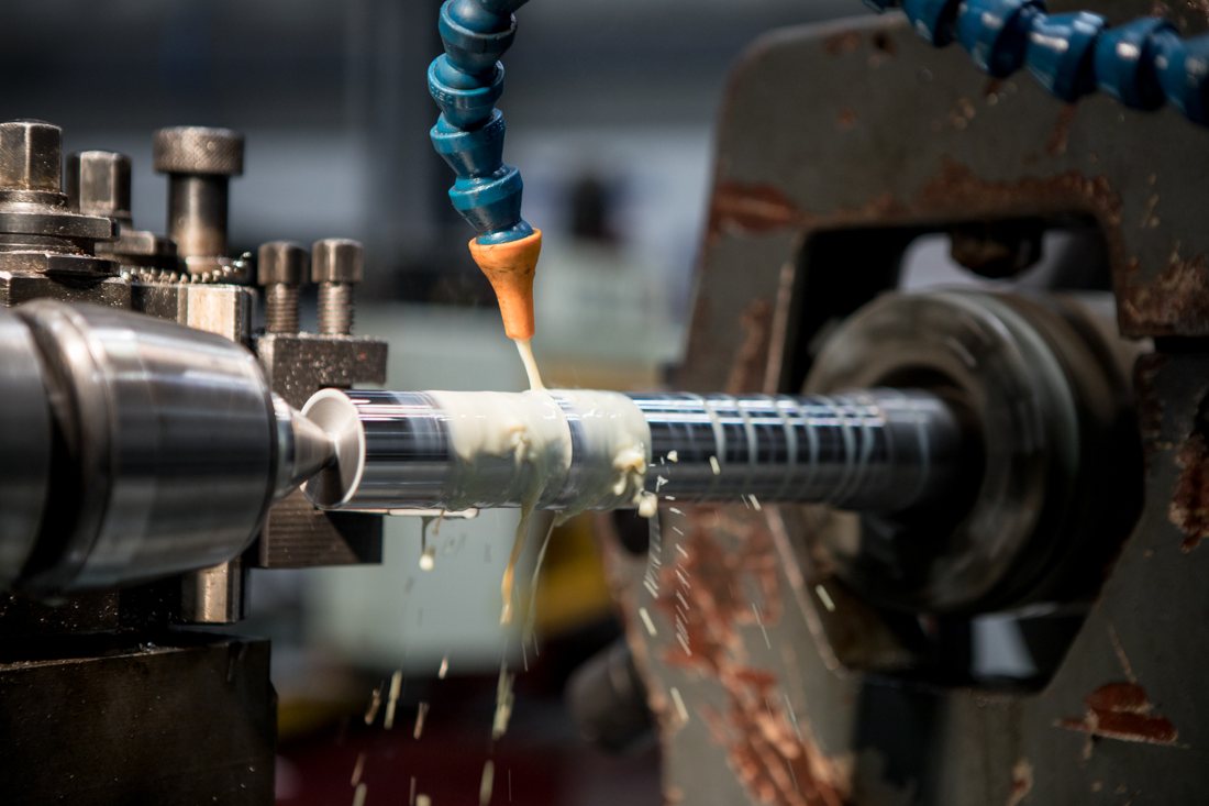 Coolant flowing over a shaft during precision machining
