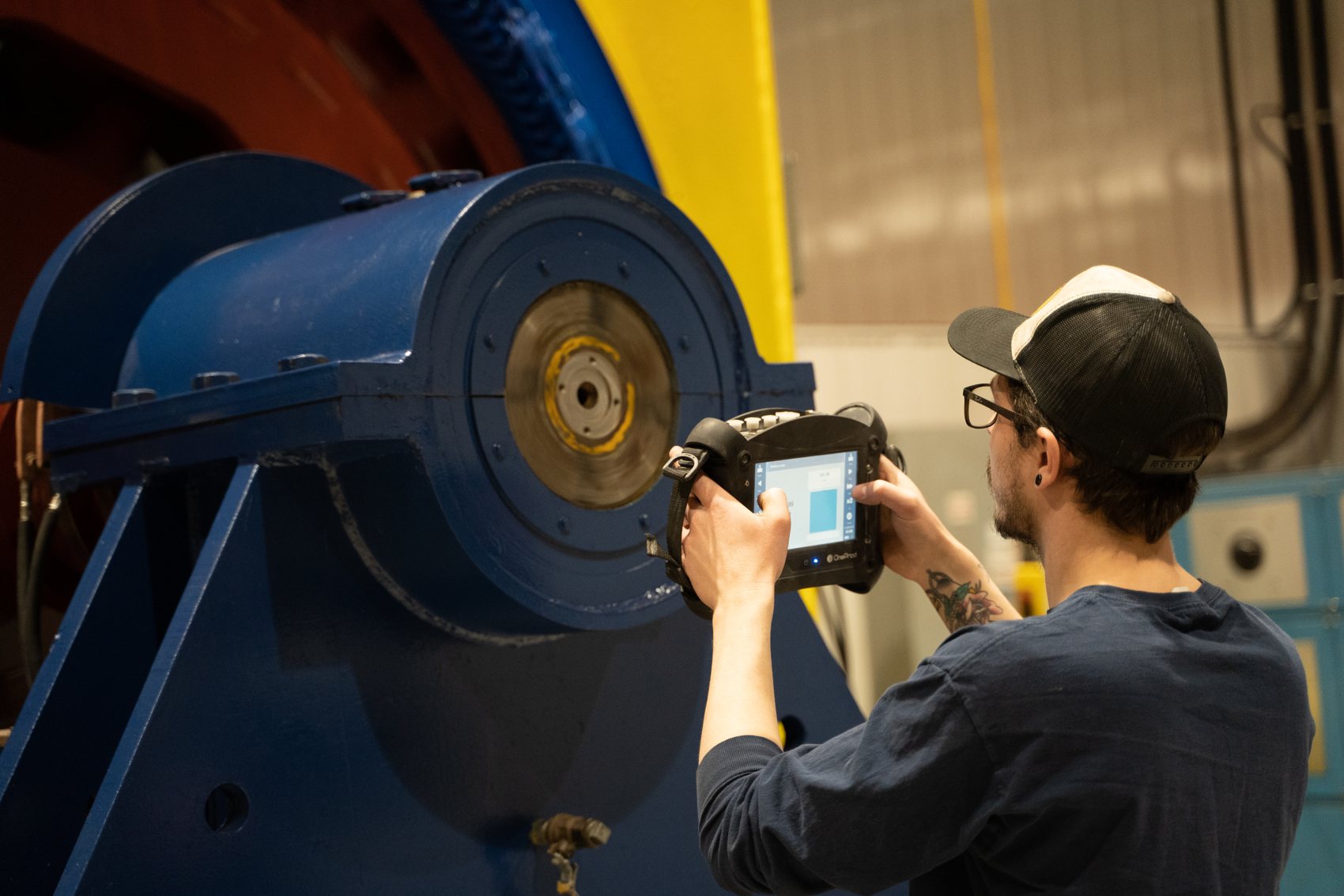 Technician taking a vibration reading with a OneProd analyzer